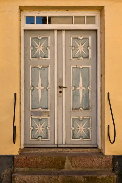 Old Double-door in a yellow house