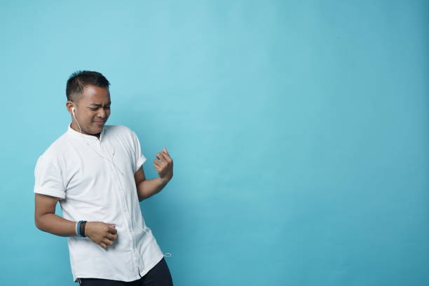 istock Enjoying Hearing Music on Earphone Southeast Asian Man - Copy Space 1208326361