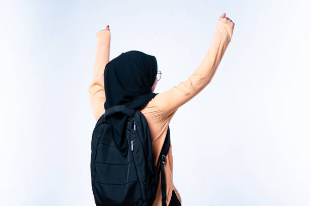 istock Happy student with arms raised on air 1208326717
