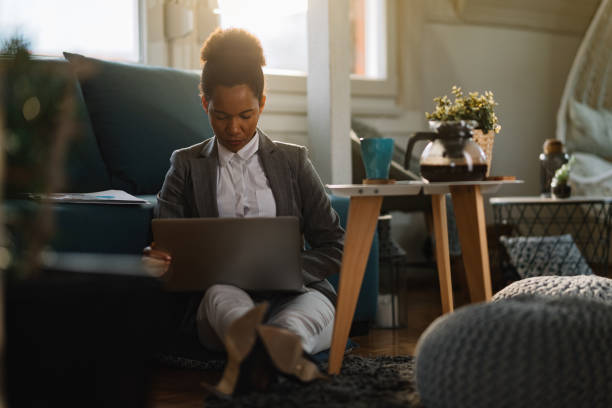 istock Black female entrepreneur working on laptop at home. 1208326912