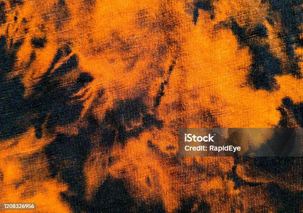 Macro Shot Of Tiedyed Textile As Background Stock Photo - Download Image Now - Tie Dye, Orange Color, Black Color