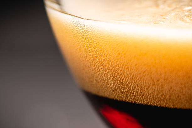 istock Freshly brewed dark beer on the black rustic background 1208327266