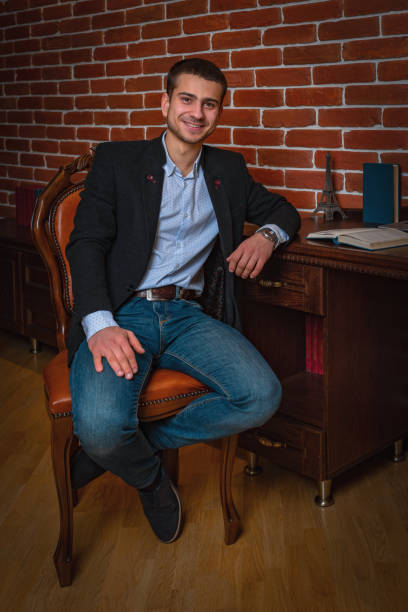 istock .Handsome young man dressed in comfortable stylish clothes for everyday work. 1208328369