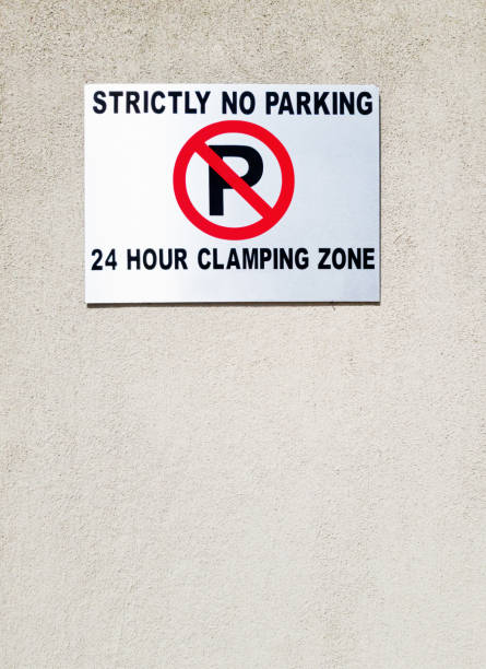 istock Strictly no parking, 24 hour clamping zone warns sign 1208328747