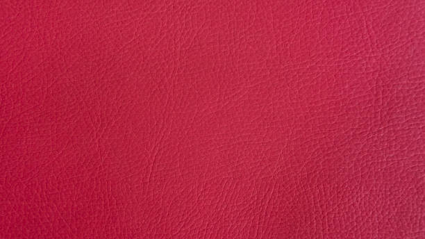 istock Carmine-crimson artificial or synthetic leather background with neat texture and copy space 1208332711