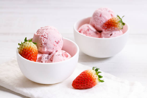 istock strawberry ice cream scoops with fresh strawberries 1208333716