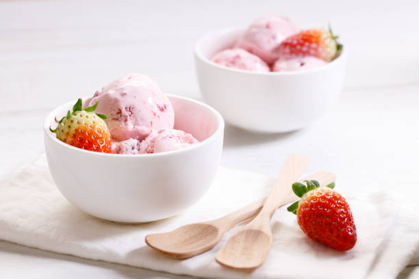 istock strawberry ice cream scoops with fresh strawberries 1208333723