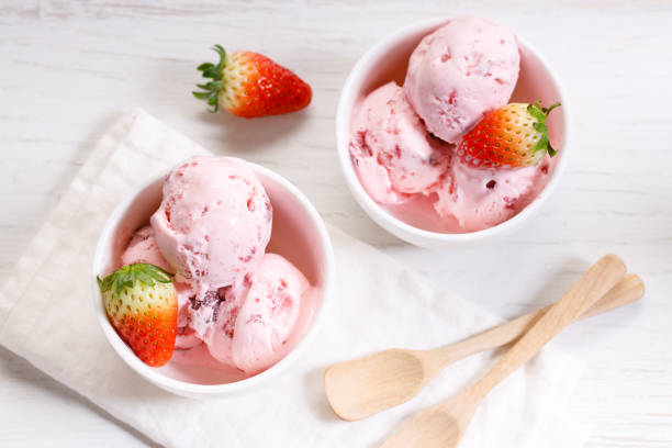 istock strawberry ice cream scoops with fresh strawberries 1208333727