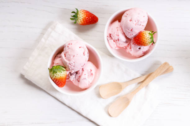 istock strawberry ice cream scoops with fresh strawberries 1208333735
