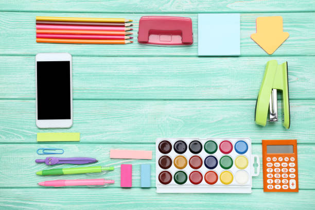 istock School supplies with smartphone on mint wooden table 1208333907