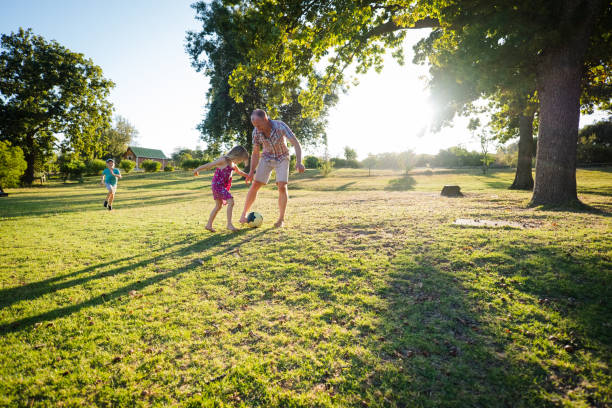 istock Kicking the soccer ball with dad 1208334644