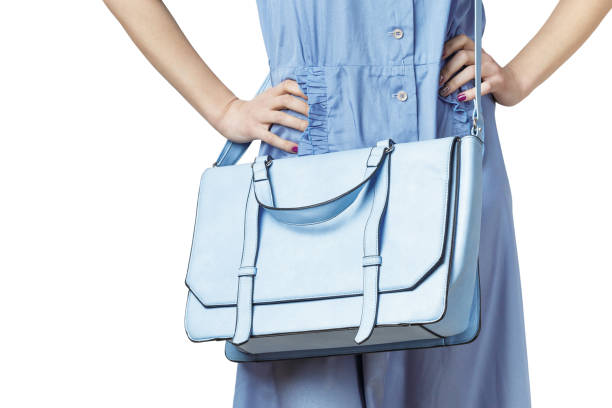 istock Woman carrying a blue messenger leather bag 1208335303
