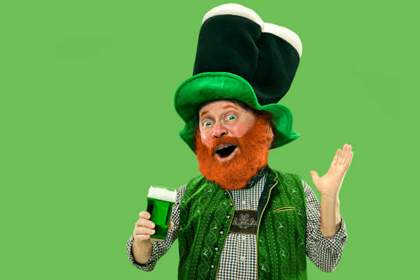 istock Excited leprechaun in green suit with red beard on white background 1208335633