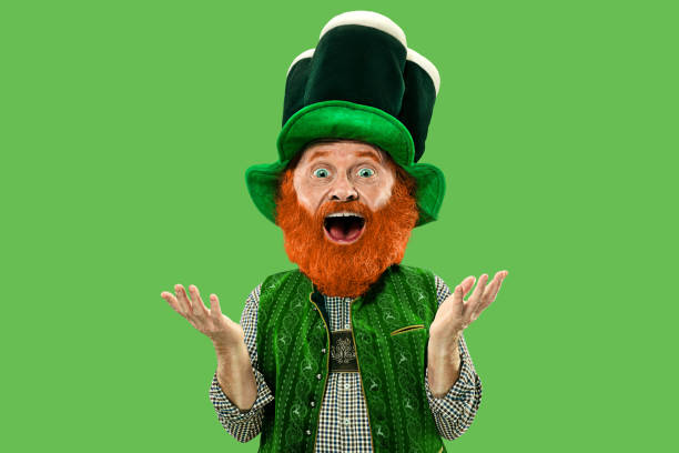 istock Excited leprechaun in green suit with red beard on white background 1208335643