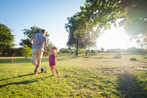 istock Father and daughter playing some soccer 1208336007