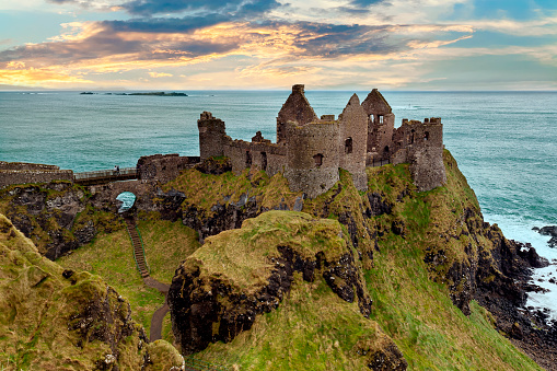 The iconic ruin of Dunluce Castle built on the dramatic coastal cliffs of north County Antrim by the MacQuillan family around 1500.