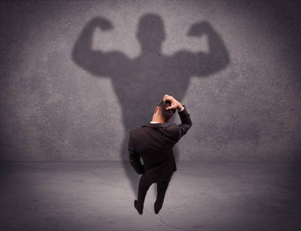 istock Successful businessman with strong shadow 1208337508