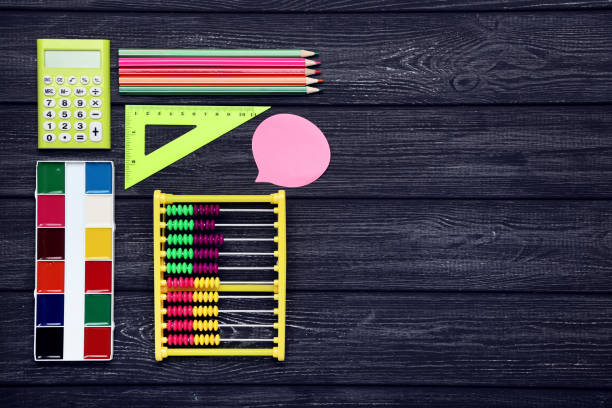 istock School supplies on black wooden table 1208337745