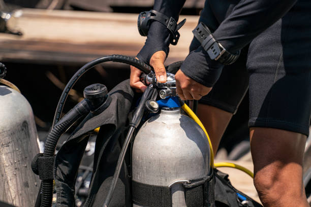 istock A scuba man preparing about oxygen tank and attaching regulator equipment 1208338713