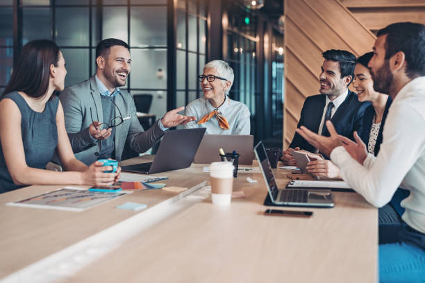 istock Mixed group of business persons around a conference table 1208340415