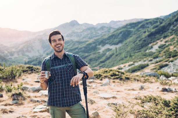 istock Hiker resting and drinking water high in the mountain 1208340429