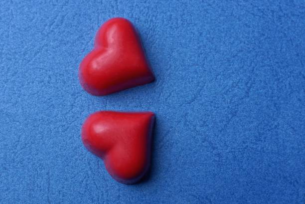 istock red hearts made of sweets lie on a blue table 1208340646