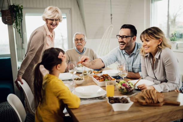 istock Happy multi-generation family having fun during lunch in dining room. 1208341514