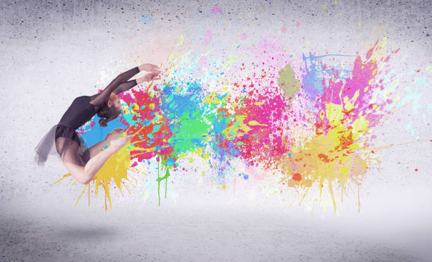 istock Modern street dancer jumping with colorful paint splashes 1208341520