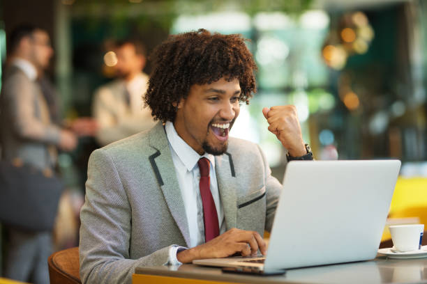 istock Technologies making life easier. cheerful young man sitting in a cafe and looking forward as he looks at his laptop 1208341637