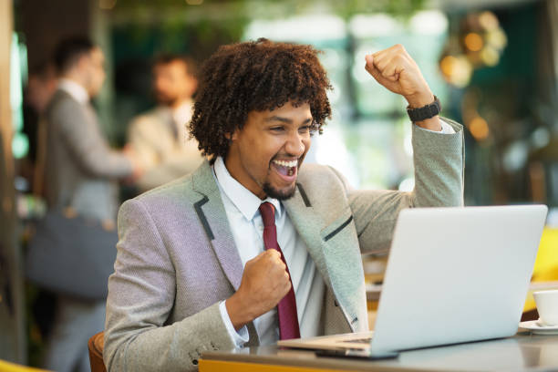 istock Technologies making life easier. cheerful young man sitting in a cafe and looking forward as he looks at his laptop 1208341642