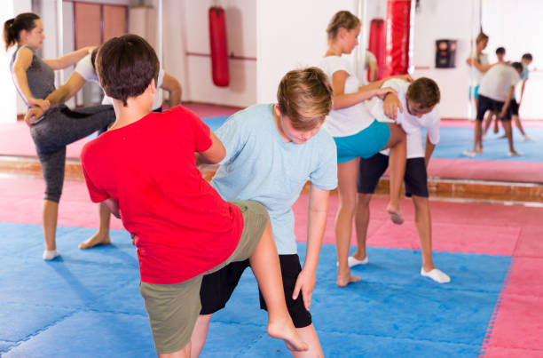 istock Kids exercising self-defense movements 1208343142