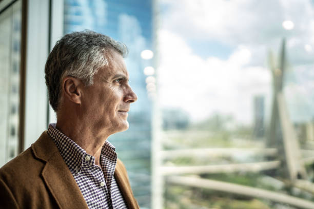 Mature businessman looking out of window