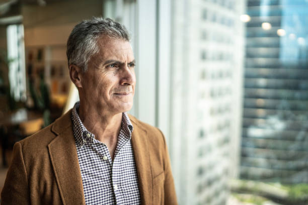 istock Mature businessman looking out of window 1208343464