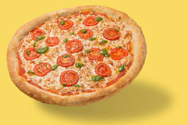 istock Italian pizza with cheese and tomatoes, levitate, cast a shadow, on a yellow background, concept, in pastel colors 1208343475