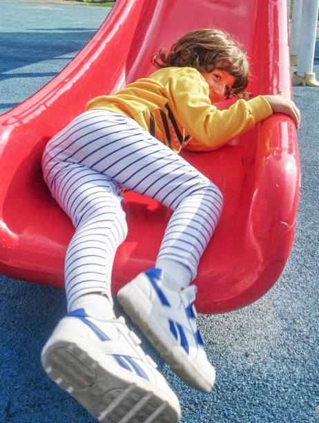 istock Excited little boy sliding down a slide 1208344890