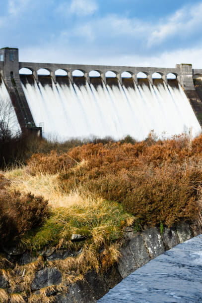istock Water flowing over the overflow sections of a Scottish dam 1208344960