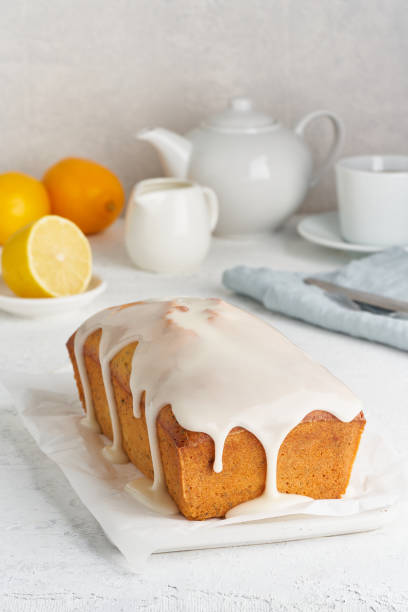 istock Lemon bread coated with sugar sweet. Cake with citrus, Whole loaf, side view, close up, vertical 1208345628