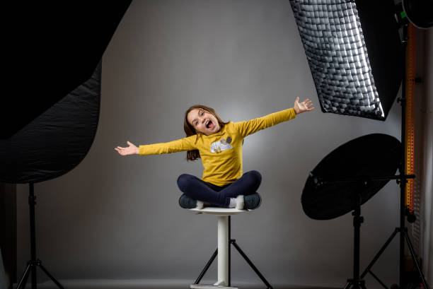 photographing children in professional photo studio with lighting equipment. - happy kid flash imagens e fotografias de stock
