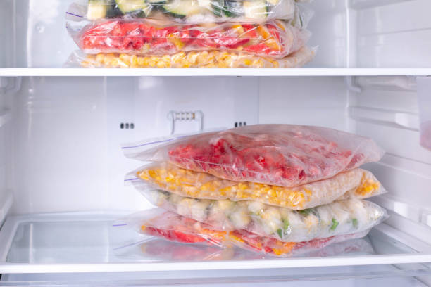 istock Plastic bags with deep frozen vegetables in refrigerator 1208345922