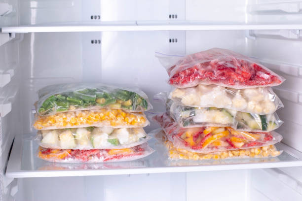 istock Bags with frozen vegetables in refrigerator 1208345928