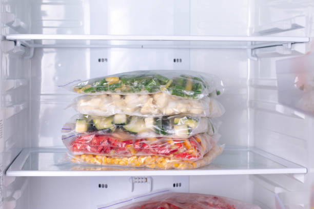 istock Bags with frozen vegetables in refrigerator 1208345955