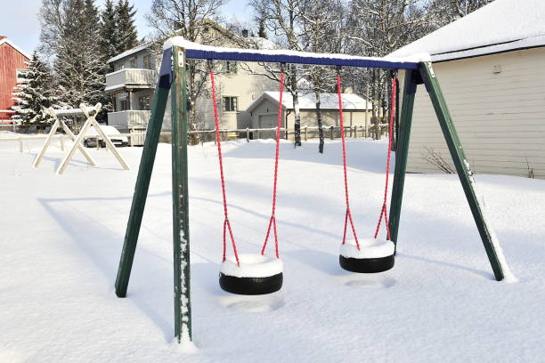 istock Snowy swing. Snowy winter in a summer park. 1208346041