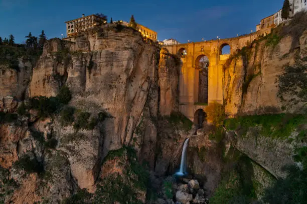 Ronda is a village in the Spanish province of Málaga. It is located about 105 km (65 mi) west of the city of Málaga, within the autonomous community of Andalusia.
The Puente Nuevo ("New Bridge") is the newest and largest of three bridges that span the 120-metre-deep (390 ft) chasm that carries the Guadalevín River and divides the city of Ronda, in southern Spain. The architect was José Martin de Aldehuela.