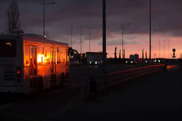 Bus at the bus stop at sunset