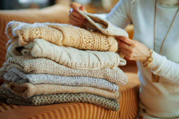 istock Closeup on trendy woman checking sweaters for damage 1208354406