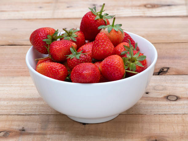 istock Fresh strawberries in a white ceramic bowl 1208354667