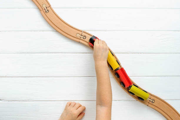 istock Child playing with wooden toy railway 1208354750