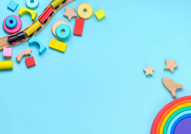istock Wooden toys rainbow, train and blocks on blue background 1208354821