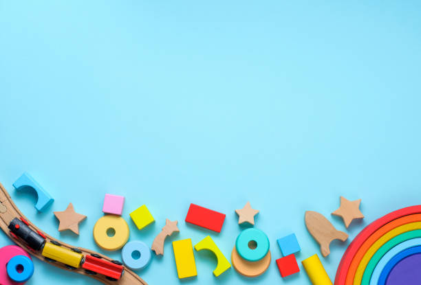 istock Wooden toys rainbow, train and blocks on blue background 1208354841
