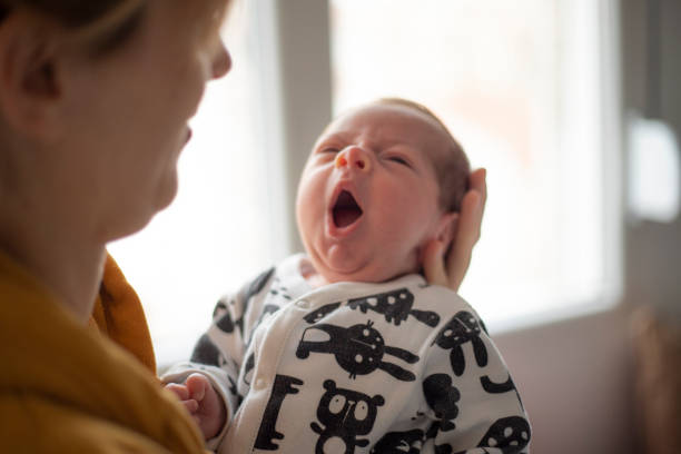 istock Sleepy Newborn Baby Yawning 1208357043